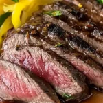 Sous vide flank steak sliced and served on a wooden cutting board
